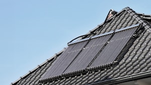 Ein neues, modernes,  graues Dach mit einer Solarthermie 