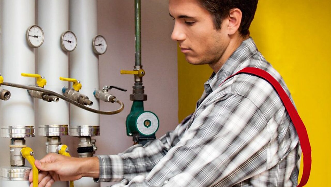 Guy cleaning oil heating system