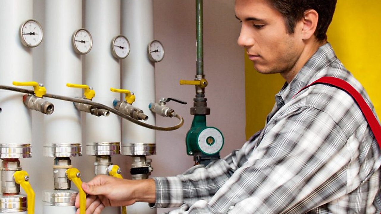 Guy cleaning oil heating system